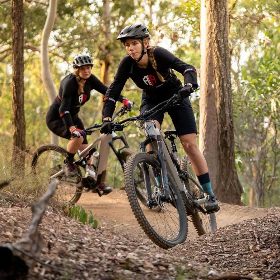 Girls on mountain bike wearing protective gear